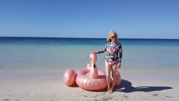 Enjoying summer vacation. Woman on beach - best swimsuits for older women