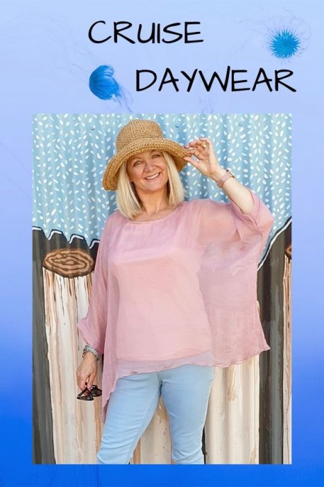 Image of woman in straw hat, pink blouse and blue jeans showing some cruise wear inspiration