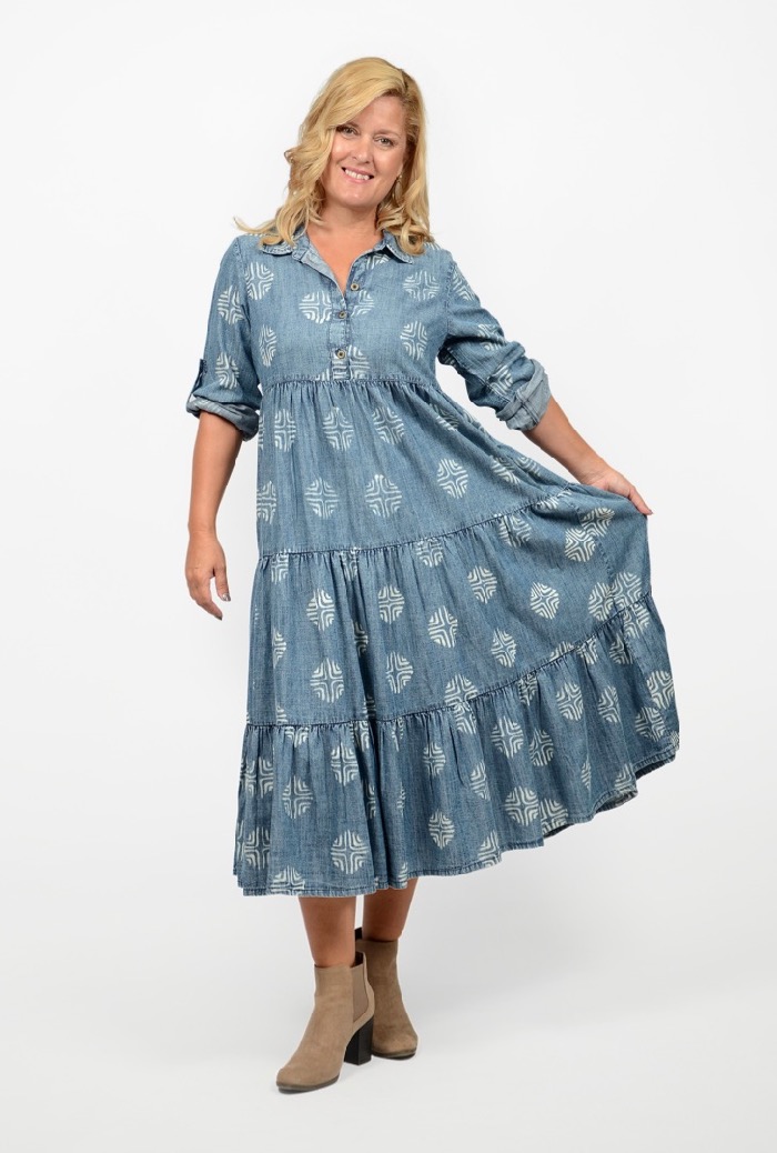 Blond woman with long hair in a blue print, denim look maxi dress. Illustrating a point in the blog post about how to look slimmer than you really are.