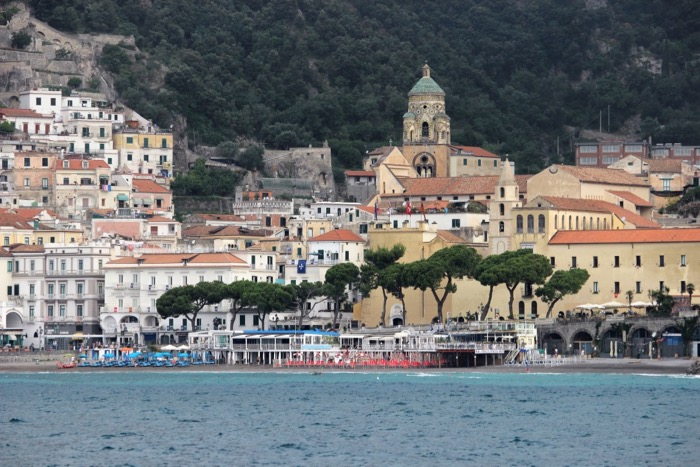 A photo showing a small town on the coast of Italy, illustrating a point in the blog post, Amazing Reasons to book a cruise vacation.