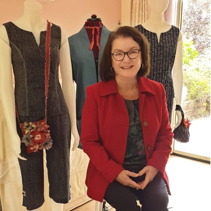 Sarah, Australian fashion designer in front of some of her cotton creations.