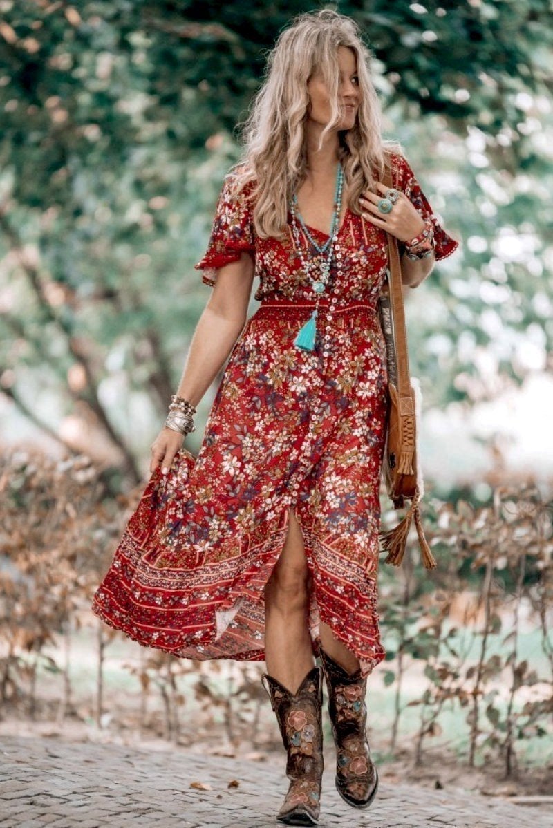 Rust coloured floral print boho dress worn by a blond model. The model is wearing elaborate cowboy boots to illustrate a point in the blog post, country dresses to wear with boots.