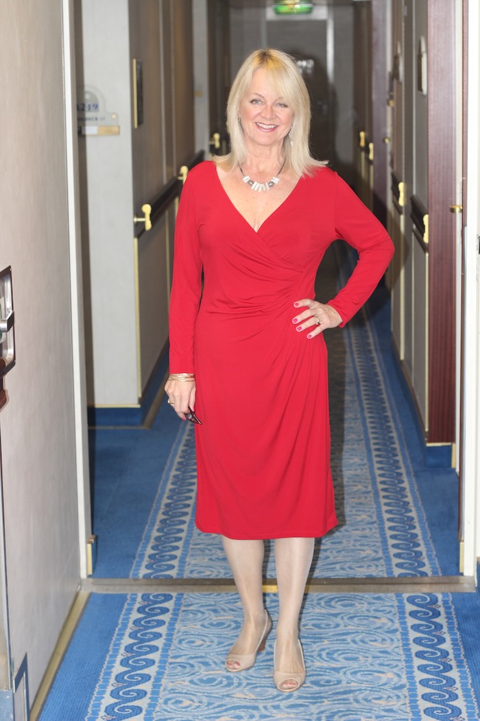 Woman wearing a red cocktail dress by Leona Edmiston