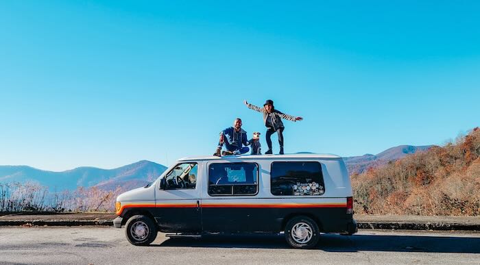 van-life-essentials, vanlife-family-posing-on-a-van