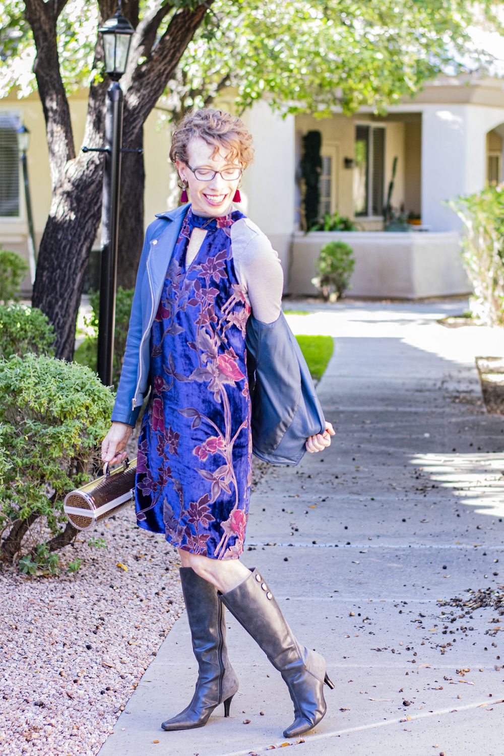 Jodie from a Touch of Style wearing a blue leather jacket and a dress