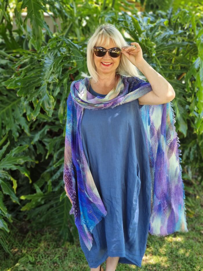 Mature aged woman in a summer dress and a cape. Illustrating a point in the blog post best summer dresses for women over 50.