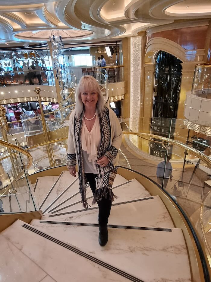 Woman walking up stairs on an Alaska cruise ship