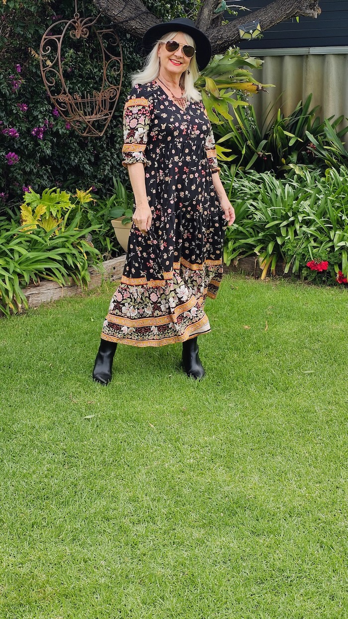 Black boho style midi dress worn with black hat and black boots.