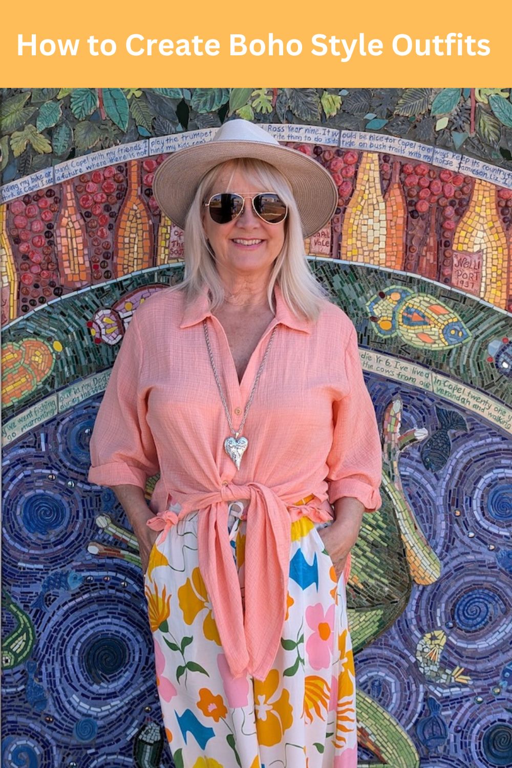 Woman wearing a salmon colored blouse and floral pants illustrating how to put together a Boho style outfit.