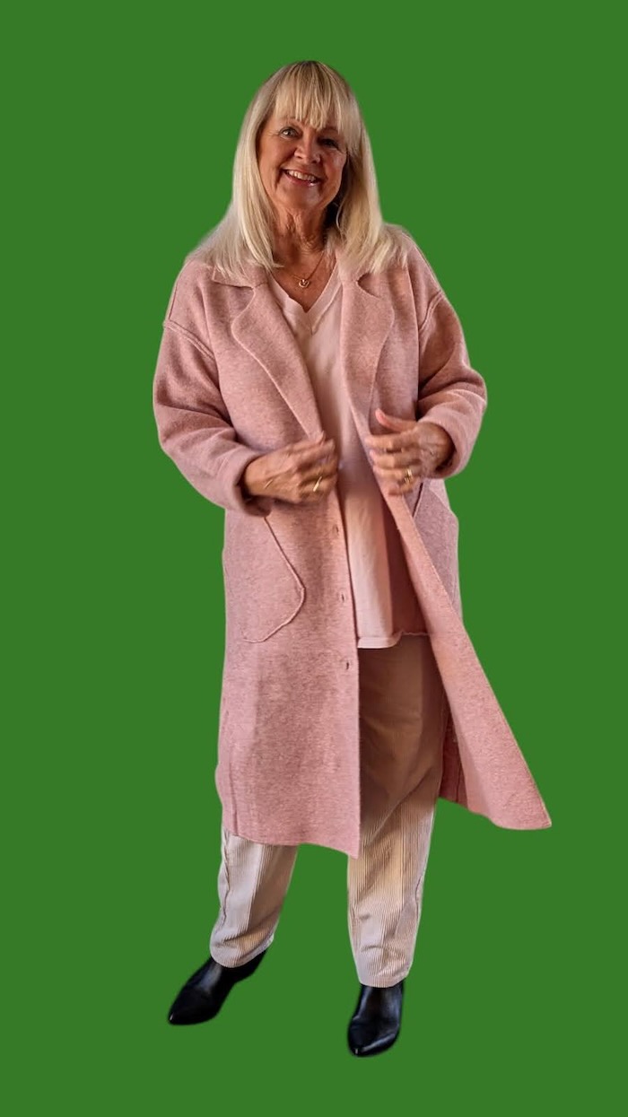 woman wearing a coatigan and cord pants.